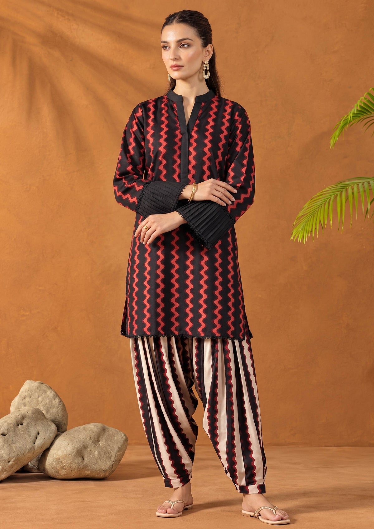 Full-length view of Crimson Ripple 2 piece printed lawn suit with black pleated cuffs and matching striped shalwar
