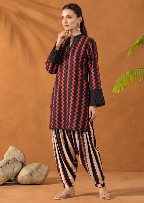 Model wearing Crimson Ripple black and red printed lawn suit with pleated cuff shirt and striped shalwar by Mirasl