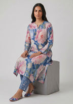 Back view of Sapphire Petals by Mirasl featuring a sapphire blue printed lawn shirt with pink, white, and powder blue floral details and matching trouser.