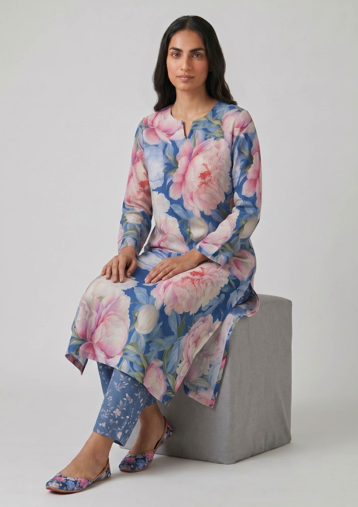 Back view of Sapphire Petals by Mirasl featuring a sapphire blue printed lawn shirt with pink, white, and powder blue floral details and matching trouser.