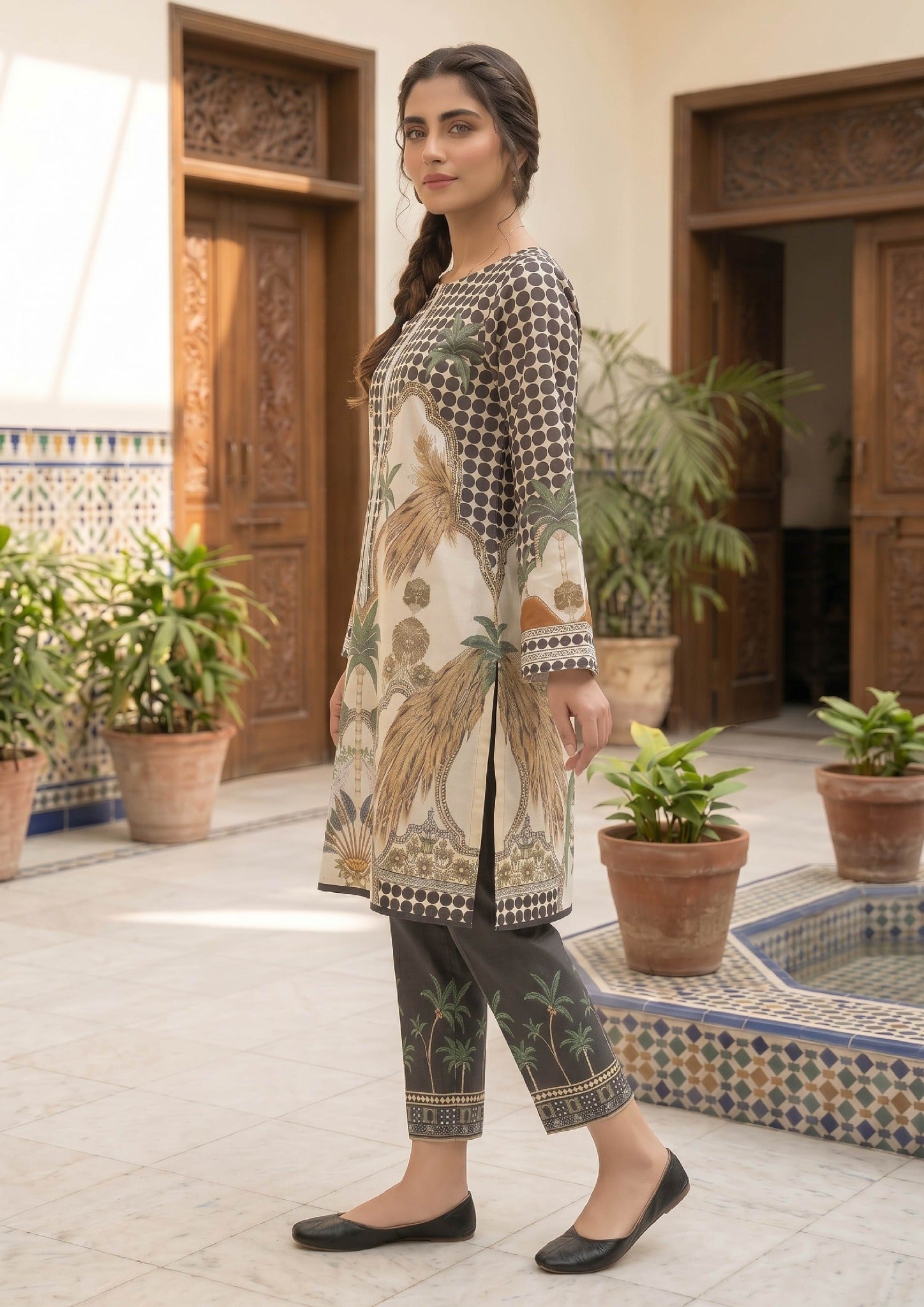 Close up of Sable Tropics printed lawn co-ord set by Mirasl with black dotted pattern, palm motifs, beige ornamental details, and ethnic border design.