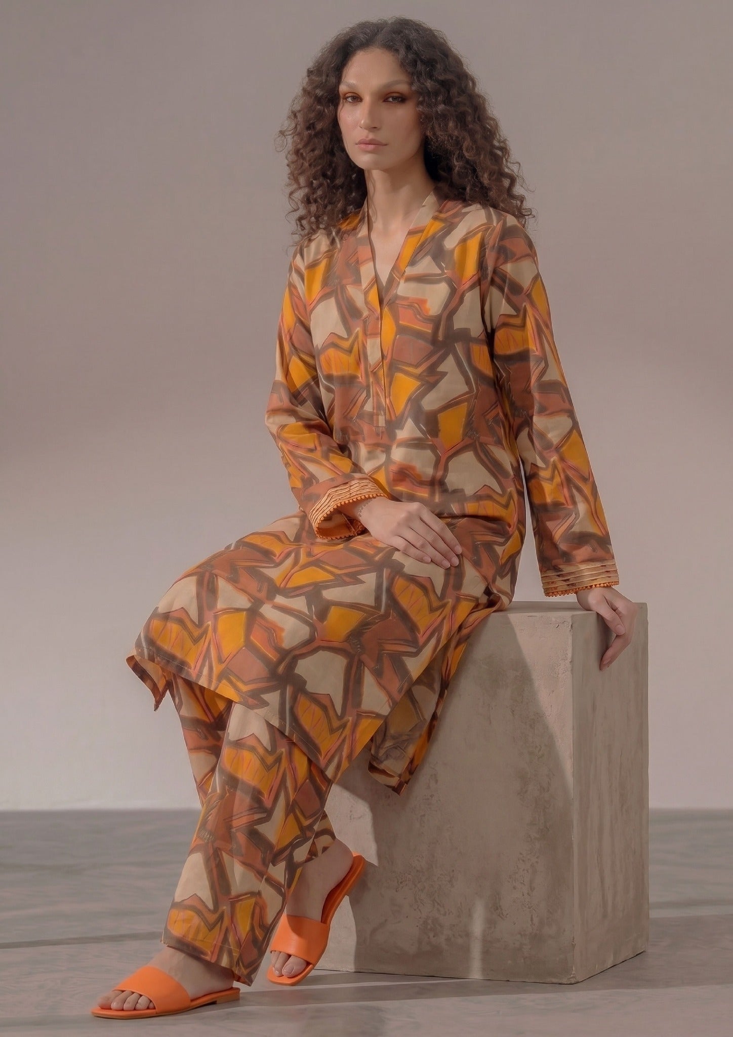 Back view of Retro Rust by Mirasl featuring a rust orange printed lawn knee-down shirt with earthy brown and mustard geometric artwork.