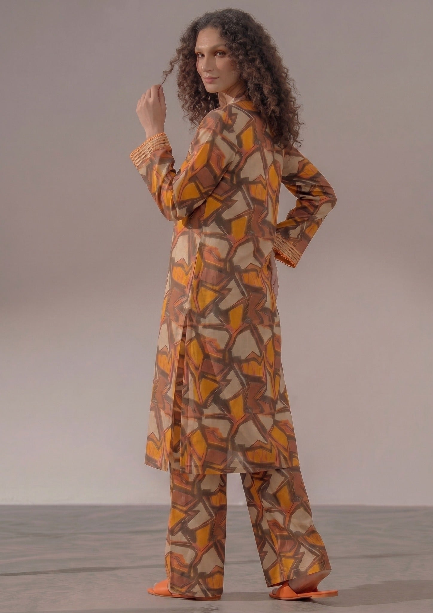 Side view of Retro Rust printed lawn co-ord set showing the relaxed straight fit, abstract geometric print, side slits, and matching wide trouser.