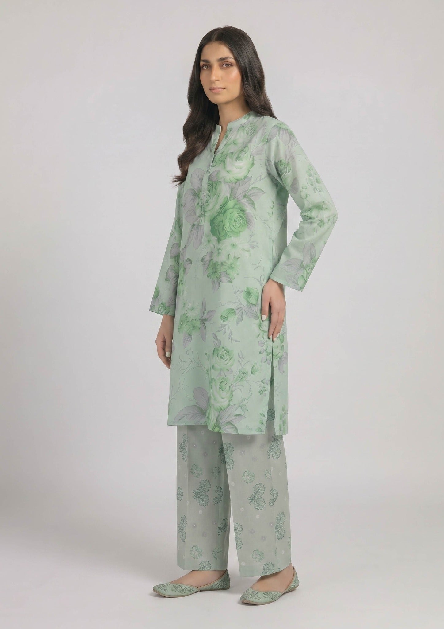 Close up of Mint Meadow by Mirasl featuring a mint green printed lawn shirt with soft green roses, grey floral details, and button placket.