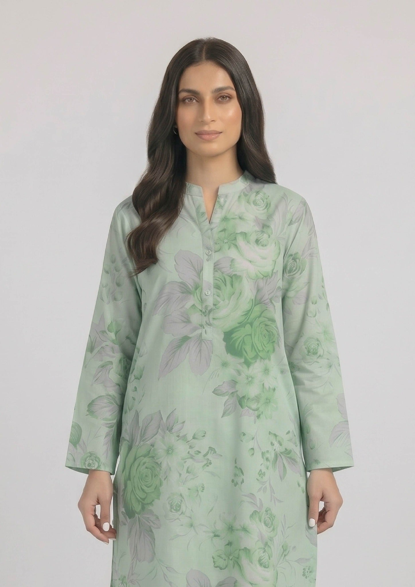 Seated model wearing Mint Meadow 2 piece printed lawn co-ord set by Mirasl with knee-level floral shirt, printed trouser, and summer ready styling.