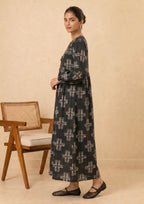Front view of Ebony Crossroad 2 piece printed lawn co-ord set by Mirasl featuring an ebony black printed lawn outfit, off-white cross motifs, tassel neckline, gathered waist detail, and relaxed flowy silhouette.