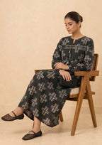 Side view of Ebony Crossroad printed lawn co-ord set by Mirasl featuring a black cross print outfit with soft drape, long sleeves, tassel neckline, and comfortable summer styling.