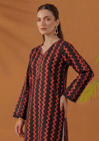 Close-up view of Crimson Ripple by Mirasl featuring black printed lawn fabric with crimson red wave motifs, V-neckline, front placket detail, and lace sleeve finishing.