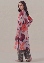 Side view of Crimson Ikat printed lawn co-ord set featuring lilac pink floral shirt, crimson and coral leaf motifs, side slits, charcoal ikat printed trouser, and easy summer styling.