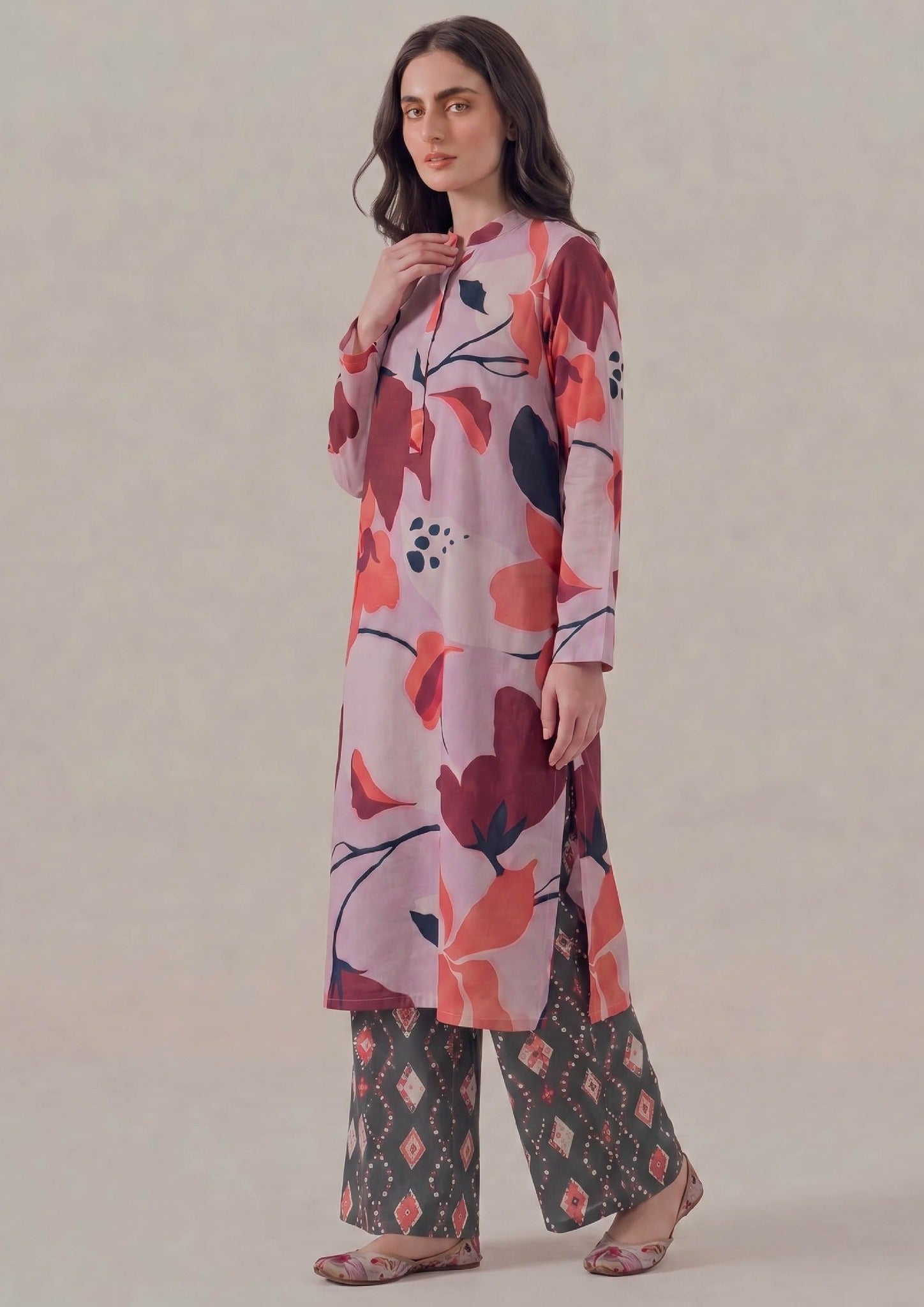 Straight front view of Crimson Ikat by Mirasl showing the knee-level floral printed lawn shirt, long sleeves, button placket detail, relaxed straight fit, and coordinated ikat trouser.