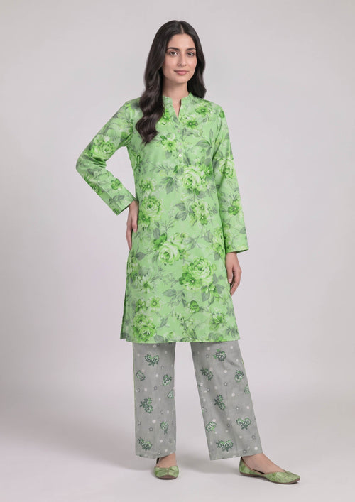 Model wearing Mint Meadow green floral printed lawn shirt with coordinated grey printed trousers by Mirasl