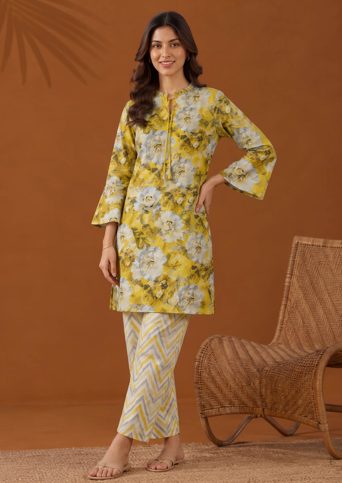 Model wearing Solenne yellow floral printed lawn shirt with coordinated cream and yellow chevron trousers by Mirasl