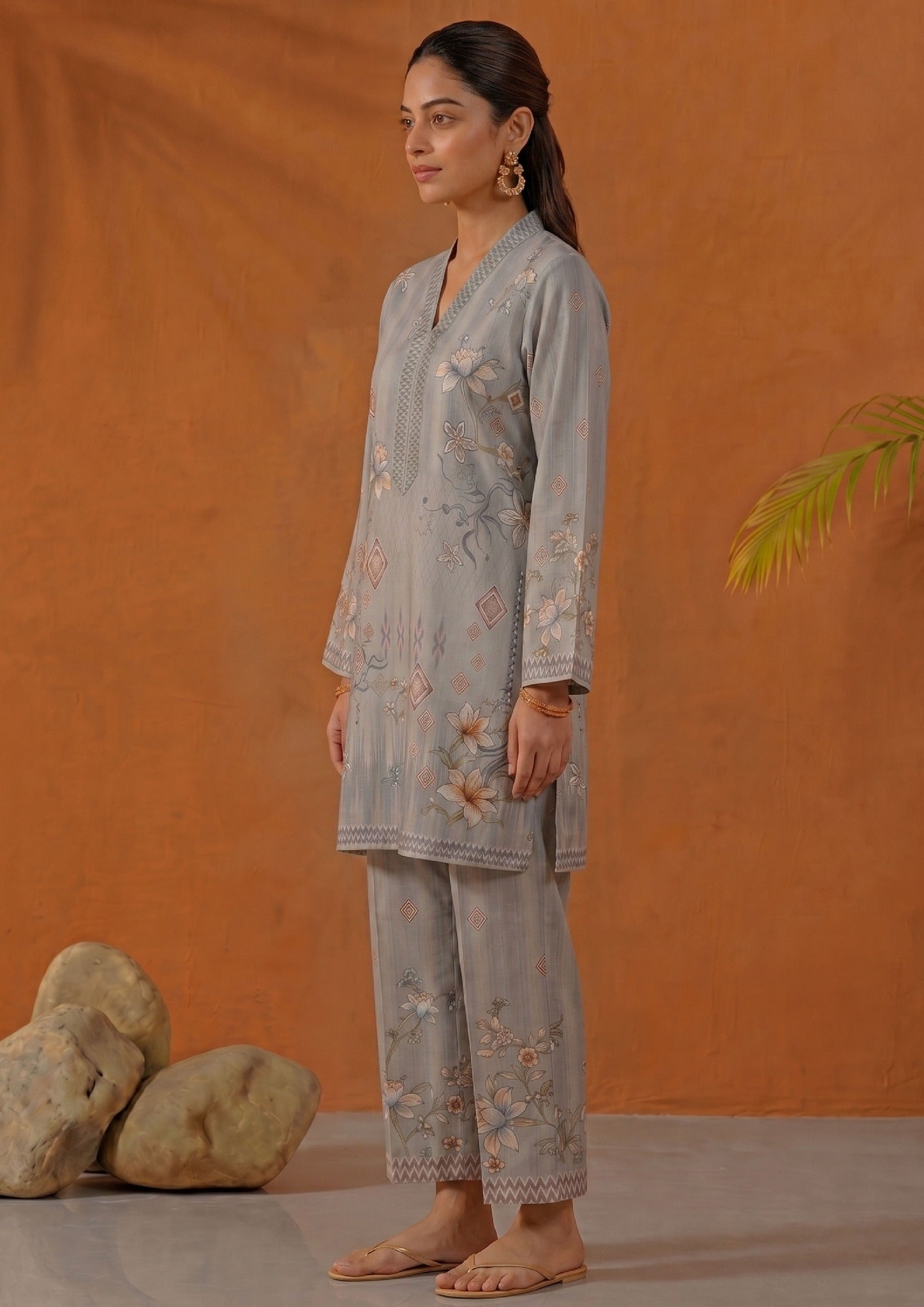 Seated view of Mirasl Aura Grey ready-to-wear printed lawn co-ord set with soft grey floral shirt and printed trouser.