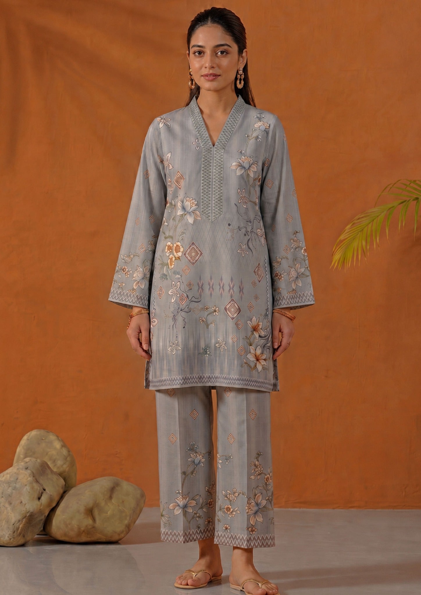 Side view of Mirasl Aura Grey printed lawn co-ord set showing grey floral knee-level shirt and matching straight trouser.