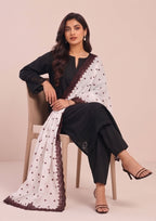 Black chikankari lawn suit with white embroidered dupatta and maroon border detailing by Mirasl