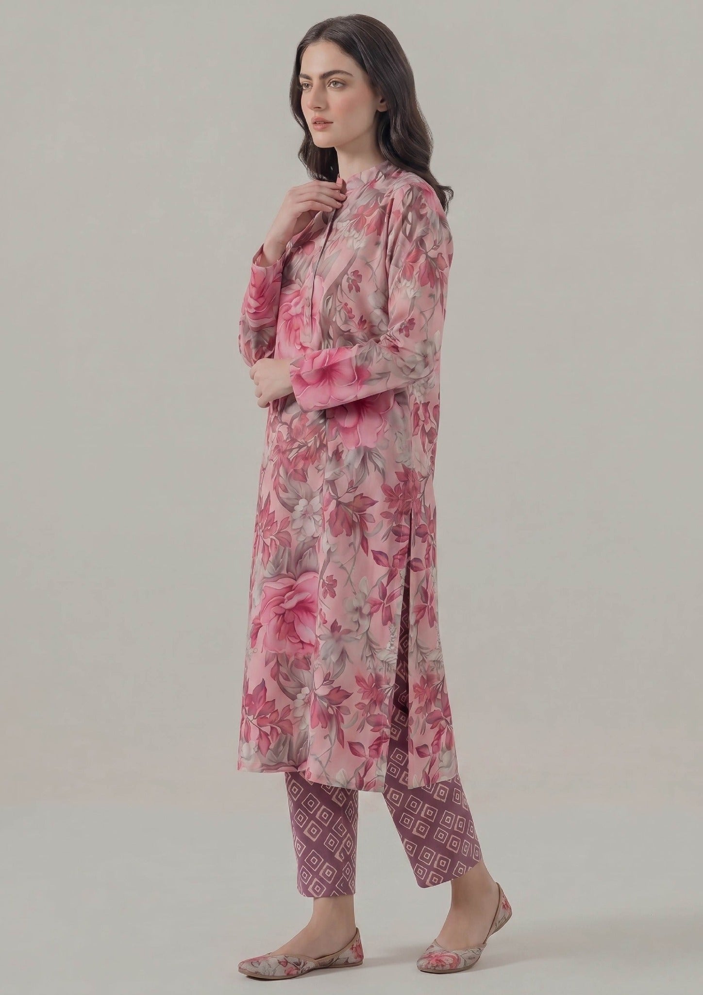 Model wearing Mirasl Blossom Fusion 2 piece co-ord set with blush pink floral printed lawn knee-level shirt and mauve printed straight trouser.