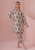 Seated view of Botanical Foliage Noir 2 Piece Coard Suit by Mirasl in ivory lawn with black foliage print and straight trousers