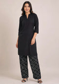 Front view of Chunri Lounge Noir black 2 piece coard suit with solid quarter sleeve shirt and wide-leg white chunri printed trouser