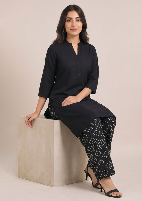 Full front look of Chunri Lounge Noir black coard suit for women with split-neck shirt and white chunri motif wide-leg trouser