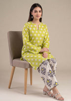 Model wearing Mirasl Citrus Chevron 2 piece co-ord set with citrus lime printed lawn knee-level shirt and contrasting printed straight trouser.