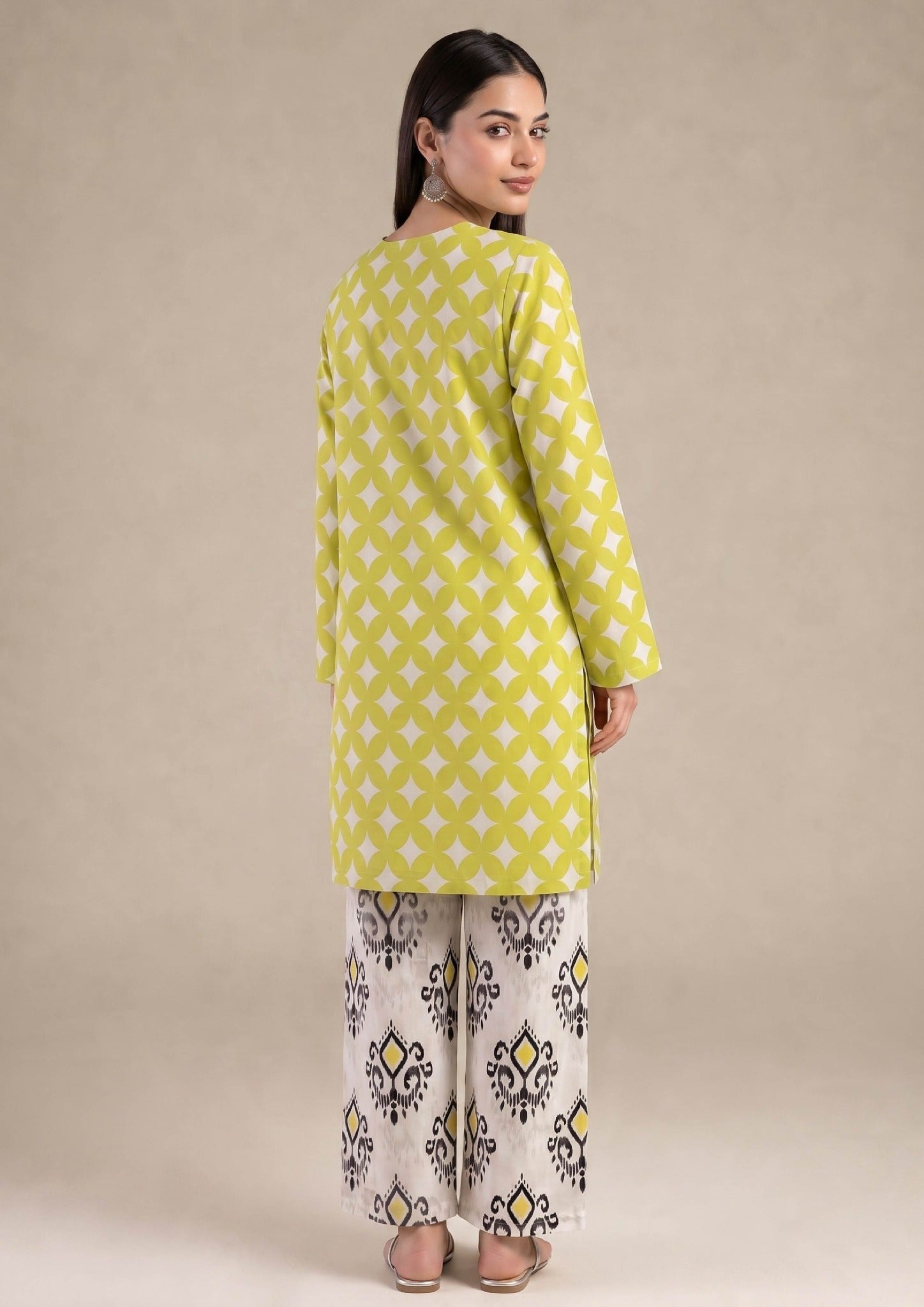Close-up of Mirasl Citrus Chevron knee-level shirt featuring citrus lime geometric printed lawn fabric and front slit neckline.