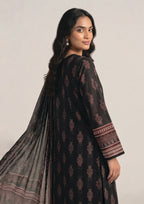 Side view of Crimson Mosaic Noir black Pakistani lawn suit showing flowing printed dupatta and geometric border