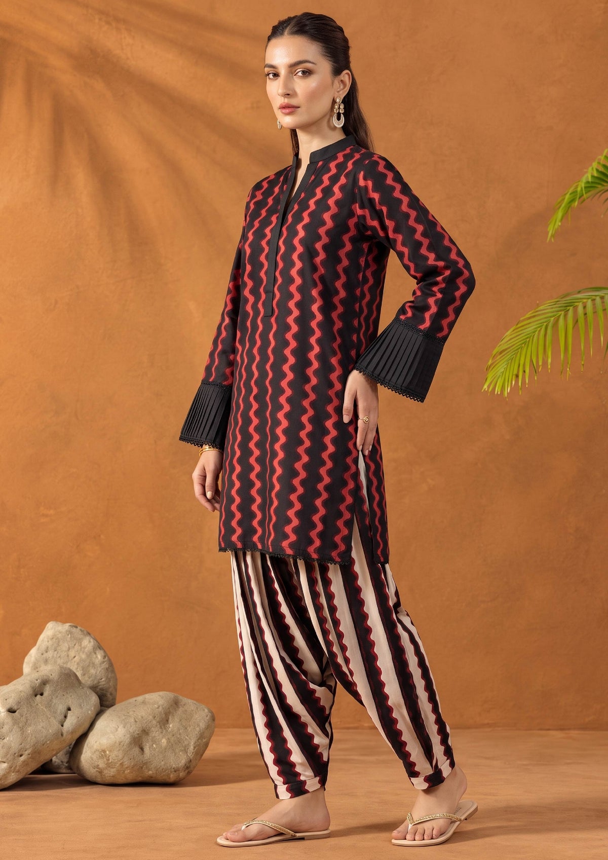 Side view of Crimson Ripple Pakistani lawn co-ord set featuring a black and red wave print shirt with printed shalwar