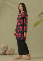 Seated view of Mirasl Dark Blossom 2 piece printed lawn co-ord set with black floral shirt and matching printed trouser.