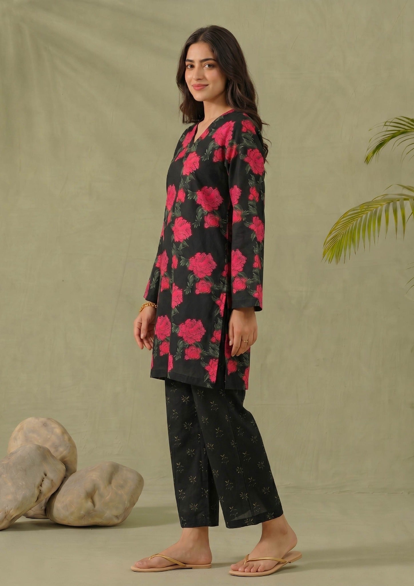 Seated view of Mirasl Dark Blossom 2 piece printed lawn co-ord set with black floral shirt and matching printed trouser.