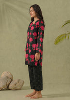 Side view of Mirasl Dark Blossom printed lawn co-ord set showing black red floral knee-level shirt and printed trouser.