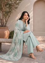 Seated portrait of a Pakistani embroidered lawn suit in mint green with a white floral printed dupatta and matching mint green palazzo trousers, perfect for luxury summer styling – fasl-e-rang – mirasl