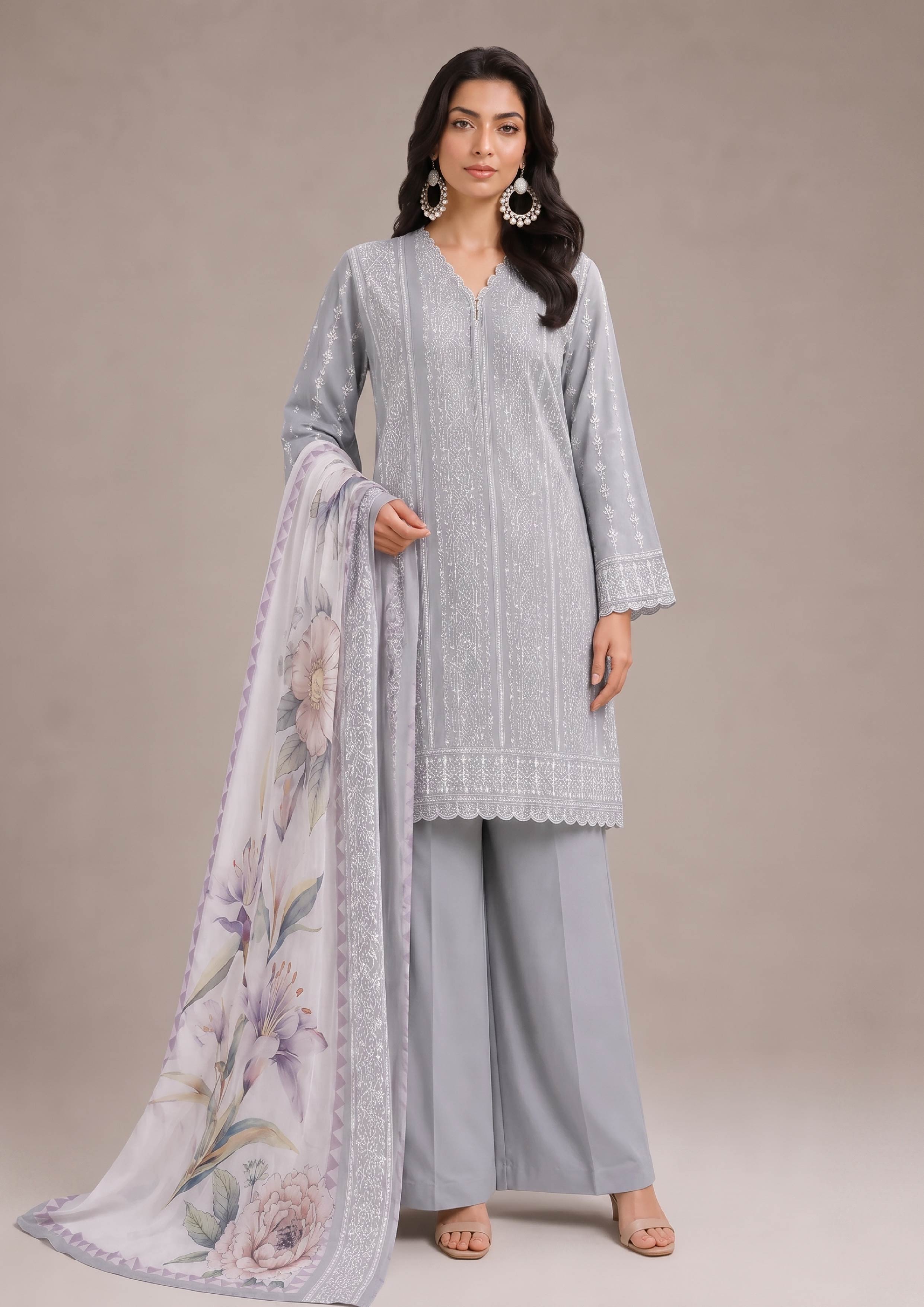 Women's embroidered lawn suit in pearl grey and mist grey with a soft lilac floral printed dupatta, front standing view featuring elegant Pakistani summer fashion from the fasl-e-rang collection by mirasl.