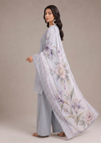 Pakistani embroidered lawn suit in pearl grey featuring mist grey trousers and a flowing soft lilac floral dupatta shown in a stylish side profile from the fasl-e-rang collection by mirasl.