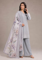 Elegant embroidered lawn suit in pearl grey with mist grey trousers and a soft lilac floral dupatta, captured in a graceful three-quarter pose from the fasl-e-rang collection by mirasl.