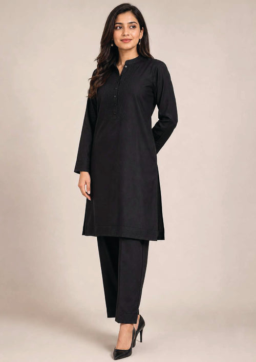 Side view of Essential Pintuck Noir black 2 piece coard suit with long pintuck shirt, side slit and straight-cut trouser