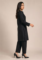 Front walking view of Essential Pintuck Noir 2 piece ready to wear suit with black pintuck shirt and straight-cut trouser