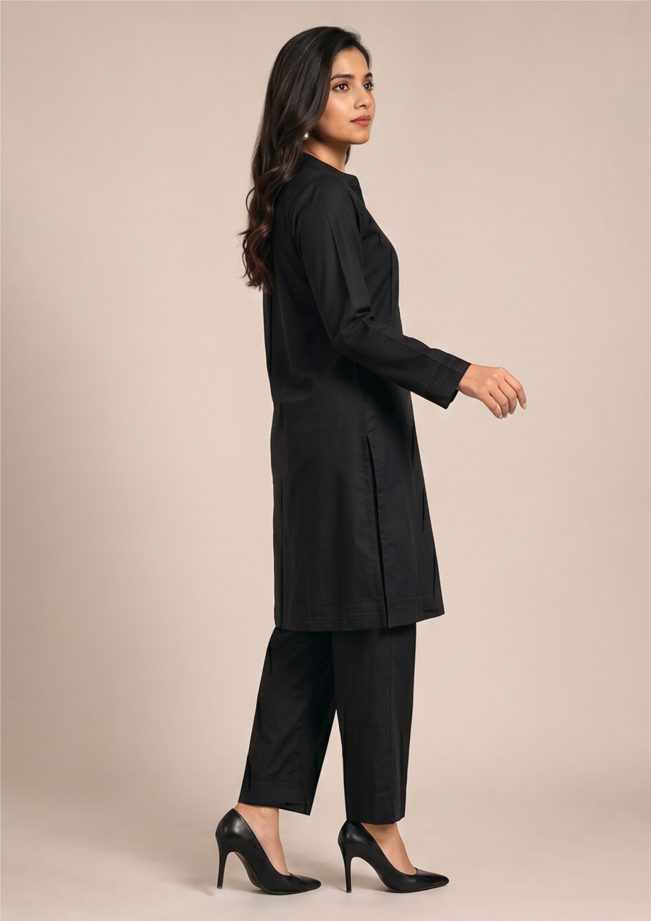 Front walking view of Essential Pintuck Noir 2 piece ready to wear suit with black pintuck shirt and straight-cut trouser