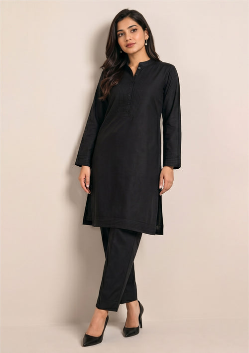 Front view of Essential Pintuck Noir black coard suit for women with band collar, tonal pintuck placket and straight trouser