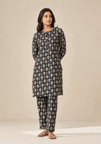 Front walking view of Floral Co-ord Noir black 2 piece coard suit with ivory floral print shirt and matching straight-leg trouser