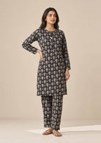 Full front view of Floral Co-ord Noir black floral coard suit with round neckline, button placket and matching printed trouser