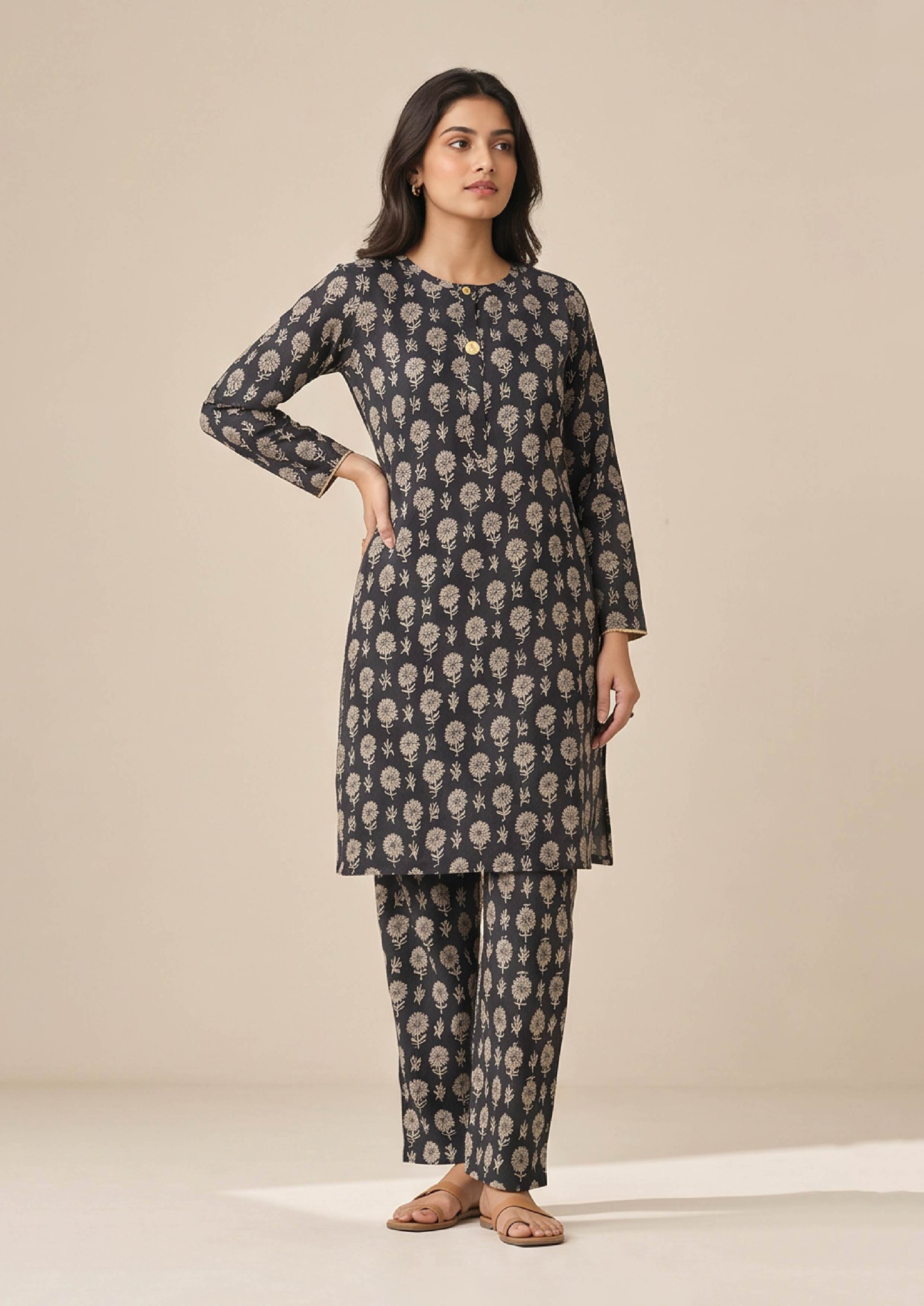 Full front view of Floral Co-ord Noir black floral coard suit with round neckline, button placket and matching printed trouser