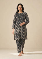 Side profile of Floral Co-ord Noir ivory floral print coard suit showing long shirt side slit and matching trouser