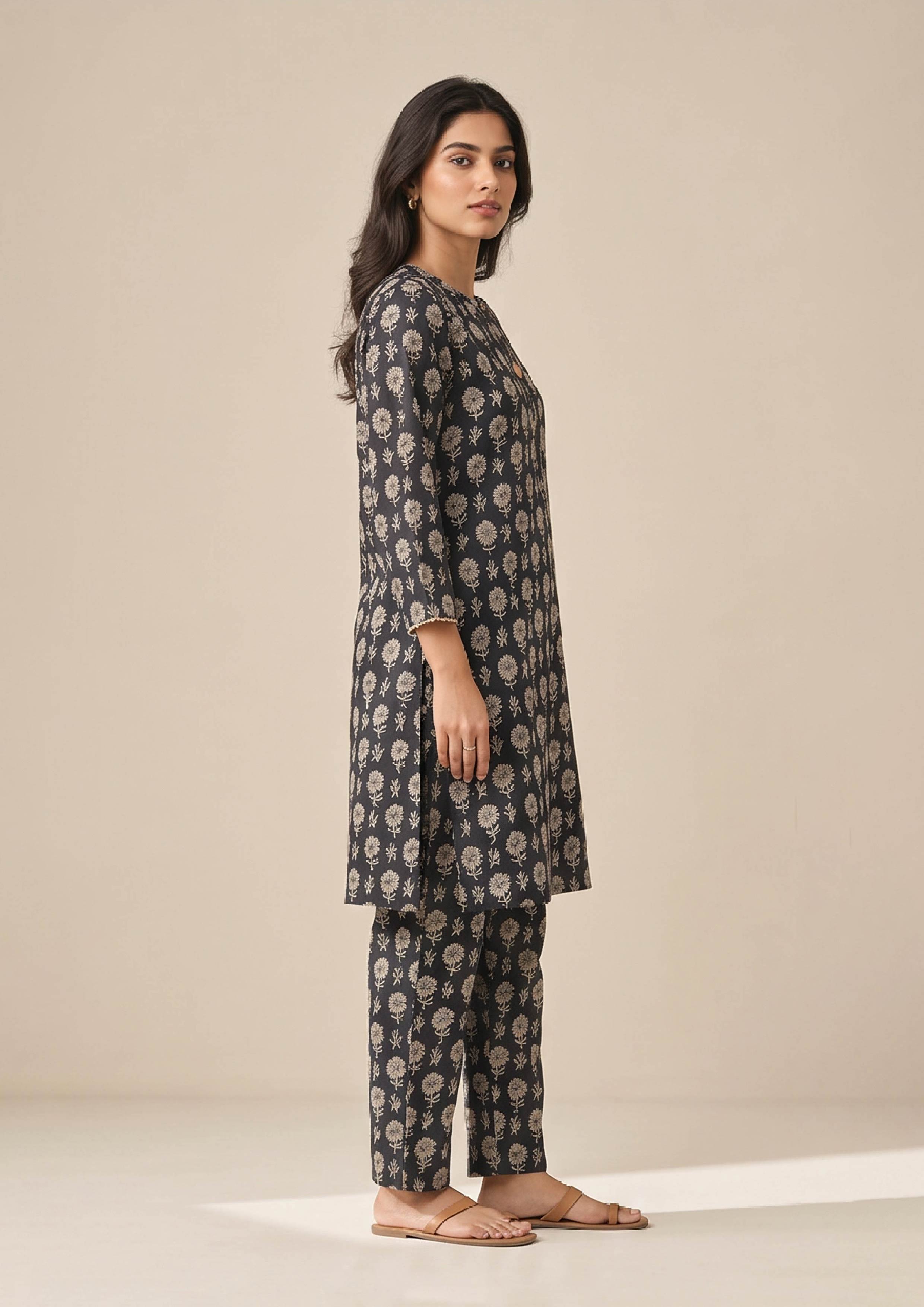 Seated view of Floral Co-ord Noir printed lawn coard suit with coordinated floral shirt and straight-leg trouser