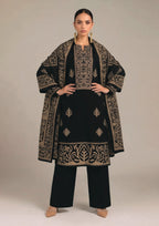 Side profile of Gilded Noir black designer lawn suit with gold printed dupatta, ornate sleeve border and wide-leg trouser