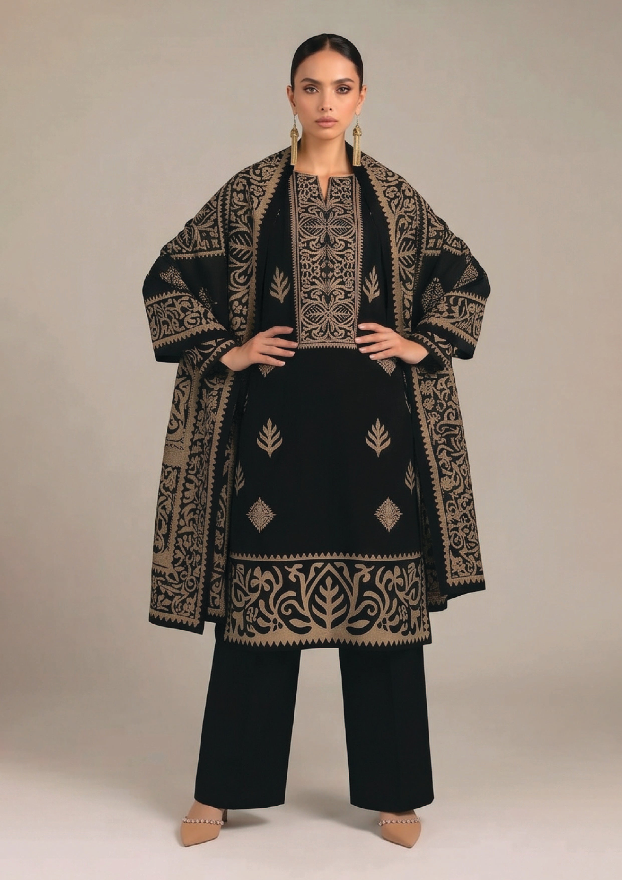 Side profile of Gilded Noir black designer lawn suit with gold printed dupatta, ornate sleeve border and wide-leg trouser