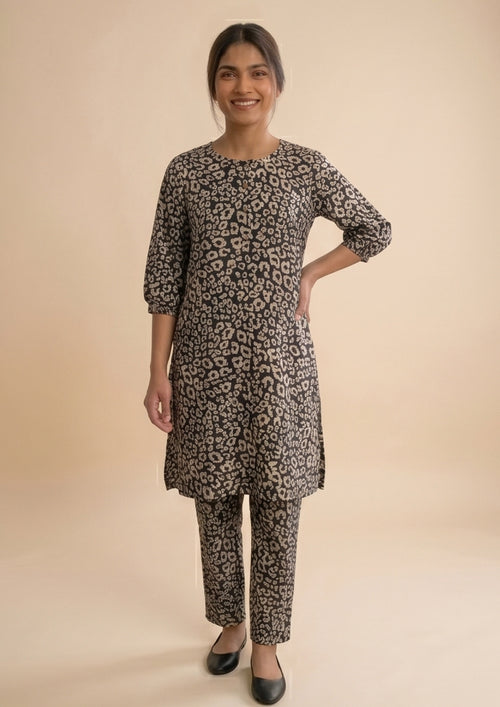 Front view of Golden Print Co-ord by Mirasl, black 2 piece coard suit with sandy gold printed lawn shirt and straight trousers