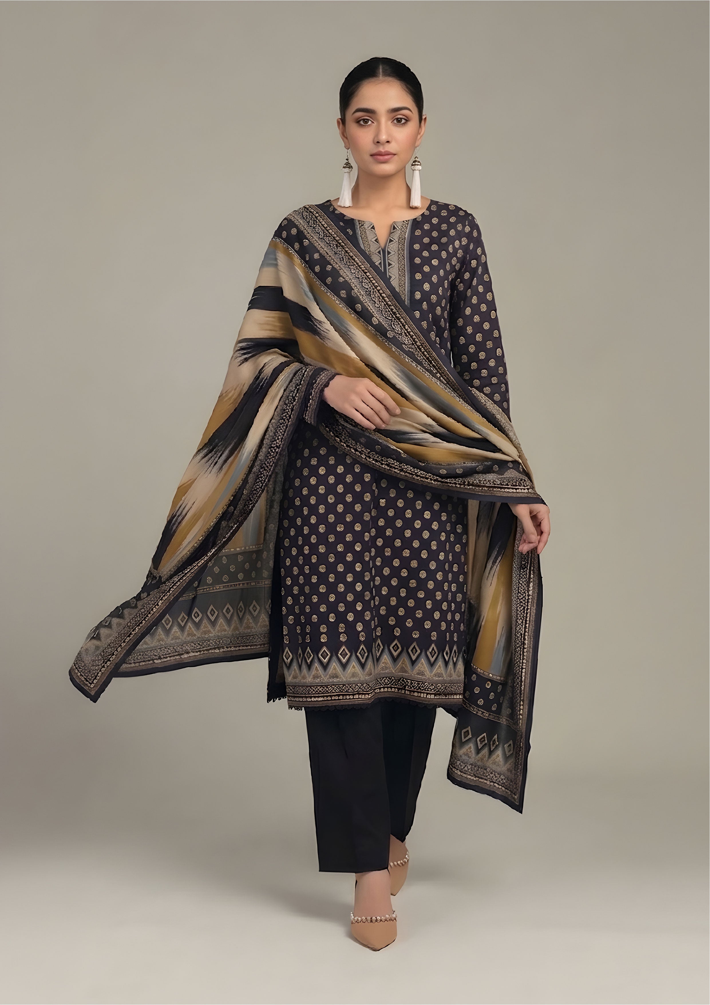 Side view of Ikat Fusion Noir geometric print lawn suit with flowing ochre and blue ikat dupatta and tailored black trouser