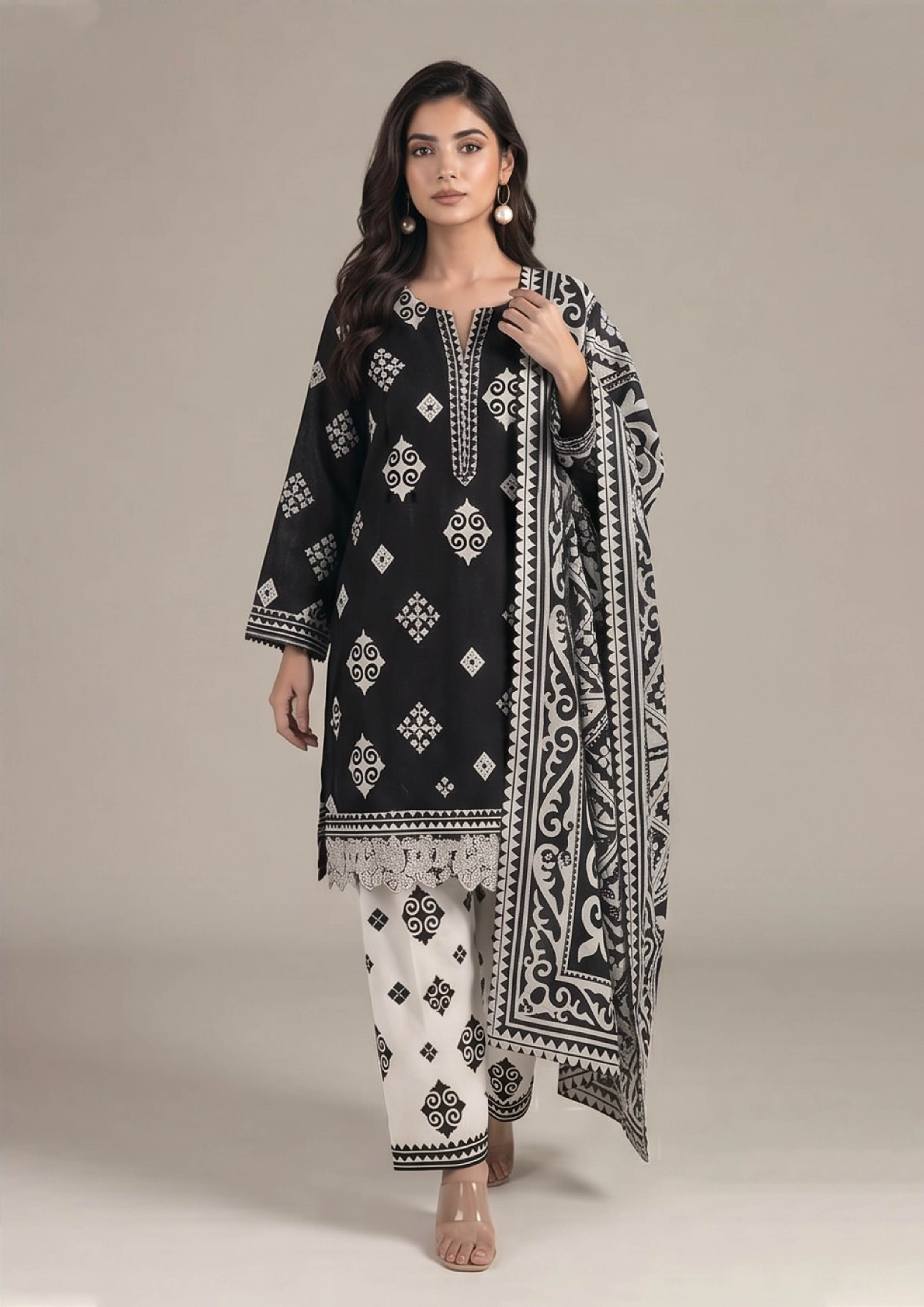 Seated model wearing Inverted Ivory Noir black designer lawn suit with ivory trouser, lace hem and statement dupatta