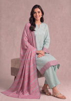 Seated view of Mint Grace Pakistani Printed Cambric Lawn Suit with coordinated pink printed dupatta and matching trousers.