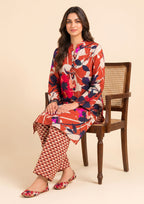 Model seated wearing Mirasl Terracotta Fusion, a ready-to-wear 2 piece stitched co-ord set with floral lawn kurti and printed trousers.